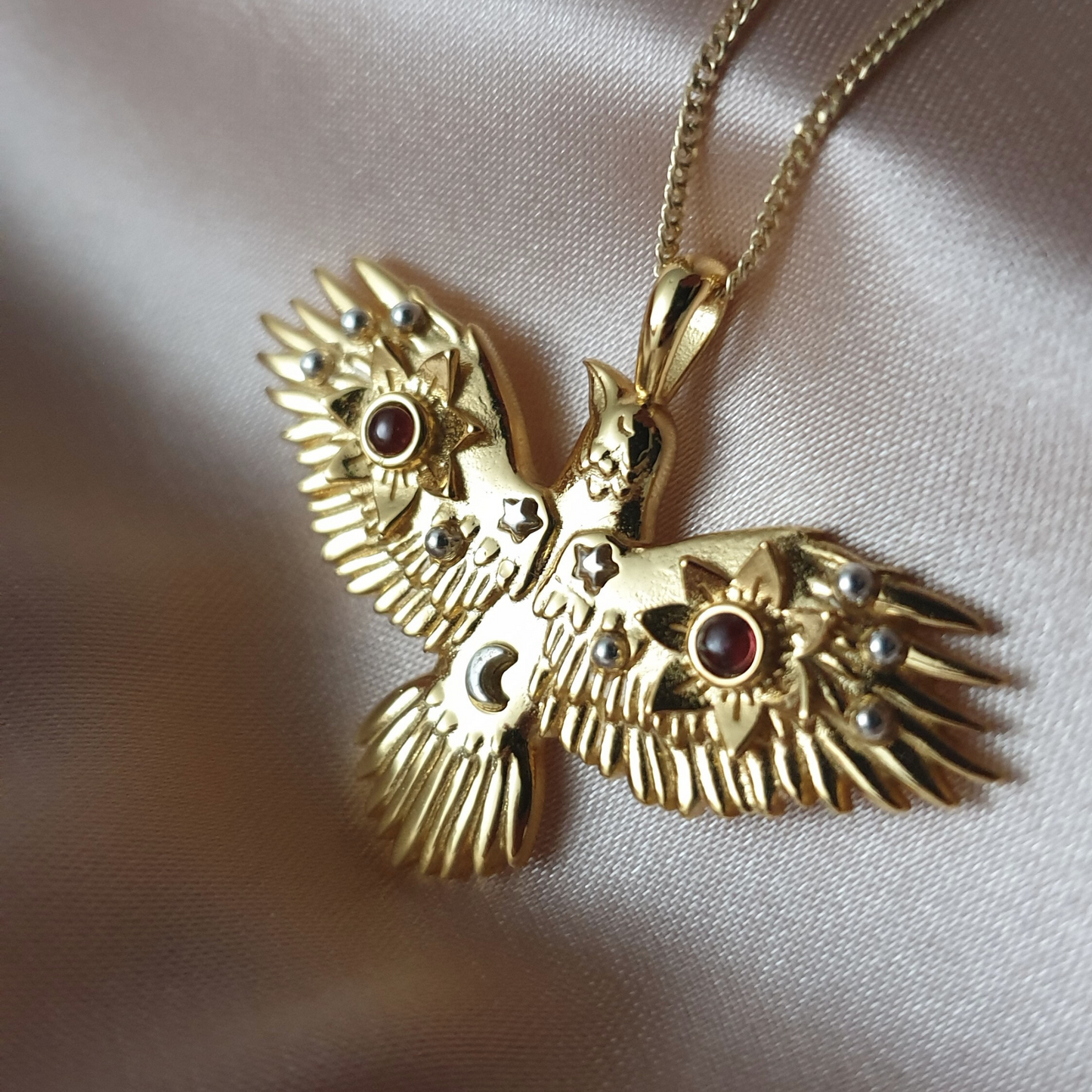 Gold Flying Crow Necklace with Garnets
