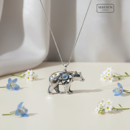 Silver bear pendant with gemstones on a white background, branded 'Serenum'.