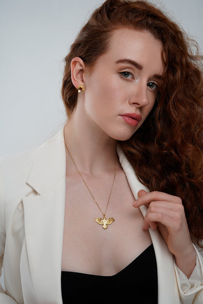 Gold Flying Crow Necklace with Garnets