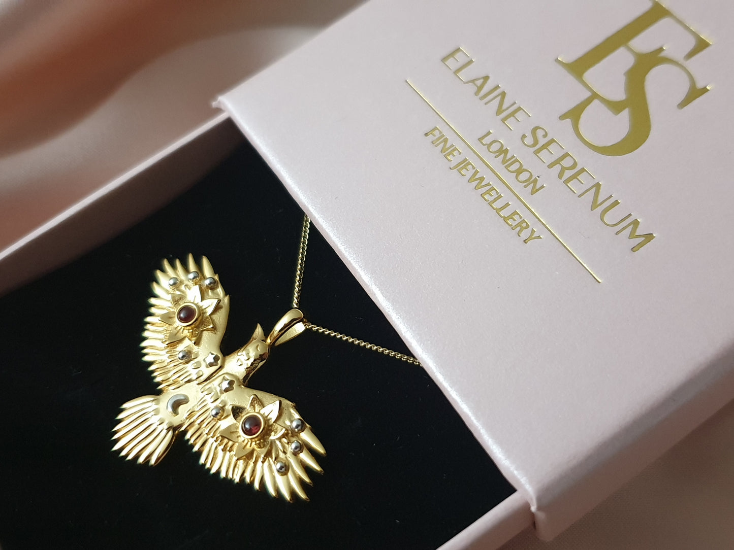 Gold Flying Crow Necklace with Garnets