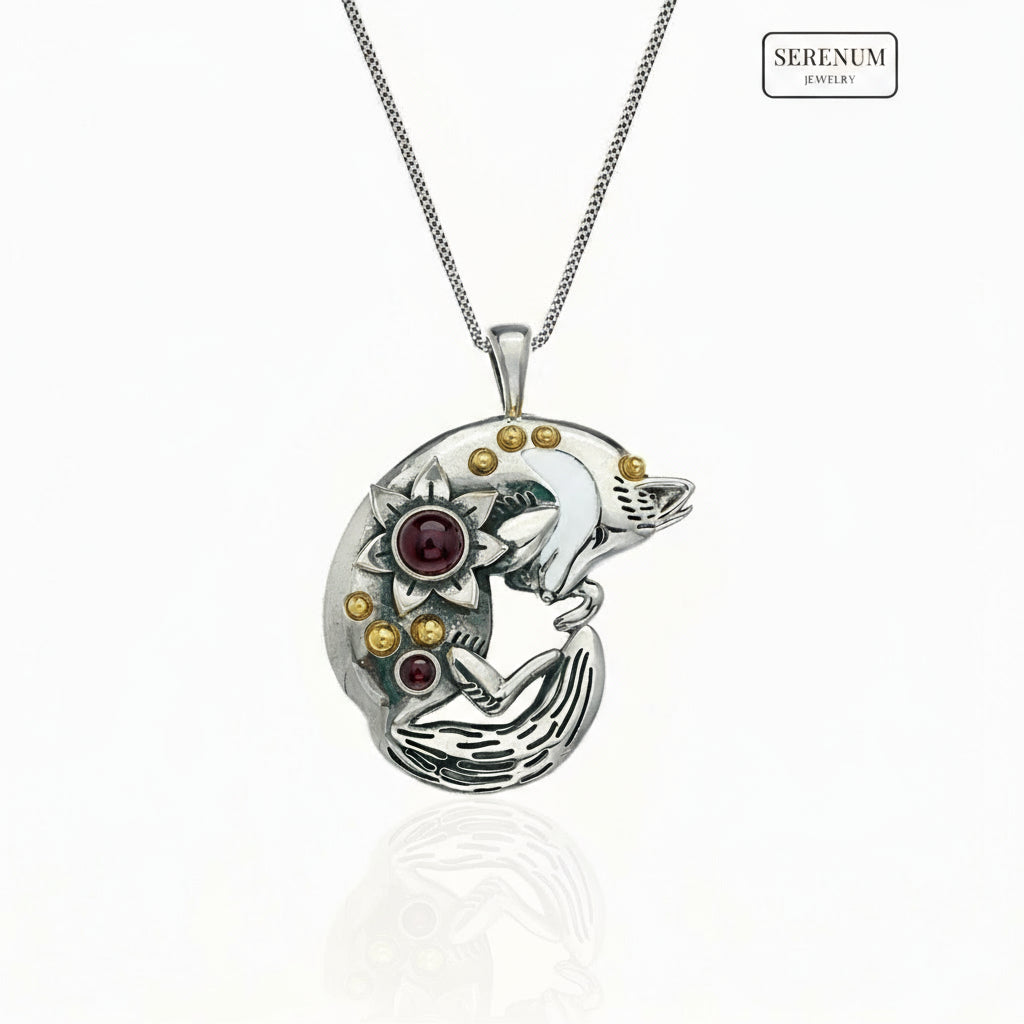 Silver pendant of a sleeping fox on a white background, branded 'Serenum'.