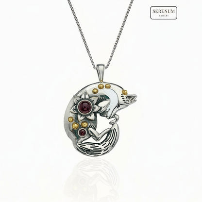 Silver pendant of a sleeping fox on a white background, branded 'Serenum'.