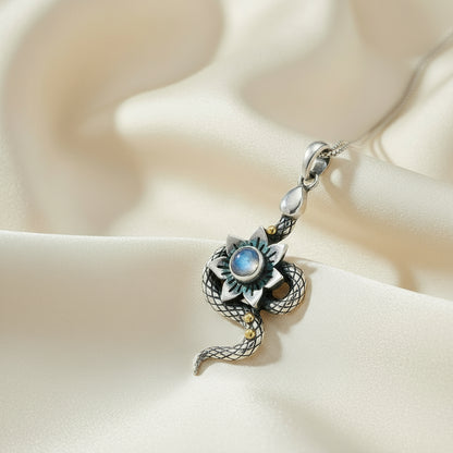 Silver snake pendant with moonstone on a white background